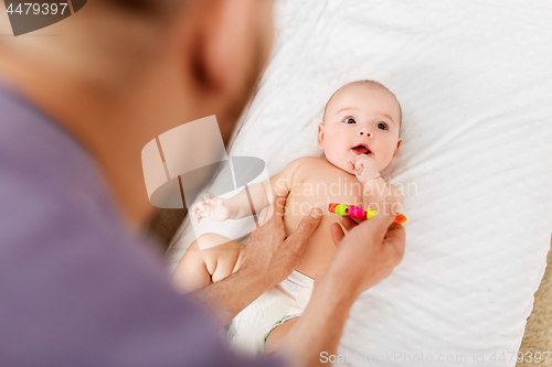 Image of close up of father and baby with rattle toy