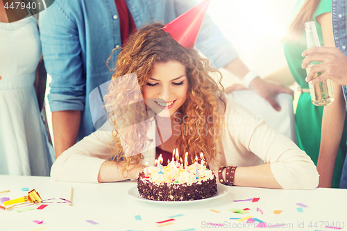 Image of happy woman with birthday cake at home party