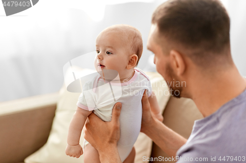 Image of father with little baby girl at home