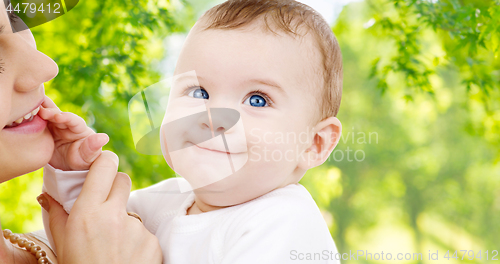 Image of mother with baby over green natural background