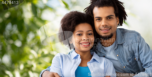 Image of happy african american couple hugging