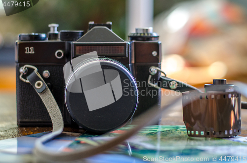 Image of Old photo film roll and retro camera on desk