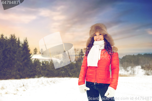 Image of happy woman in fur hat over winter background