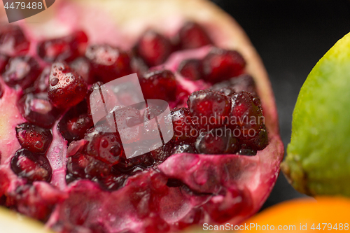 Image of close up of pomegranate on stone table