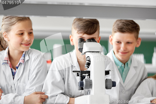 Image of kids or students with microscope biology at school