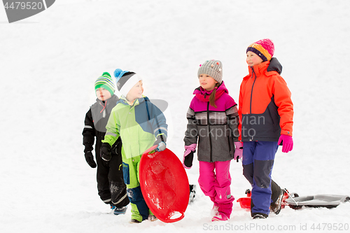 Image of happy little kids with sleds in winter