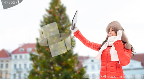 Image of woman with tablet pc over christmas tree