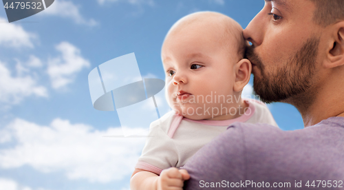 Image of close up of father kissing little baby daughter