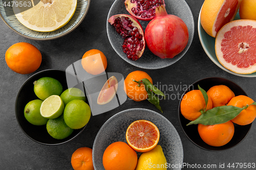 Image of close up of citrus in bowls fruits on stone table