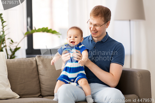 Image of happy father with baby son at home