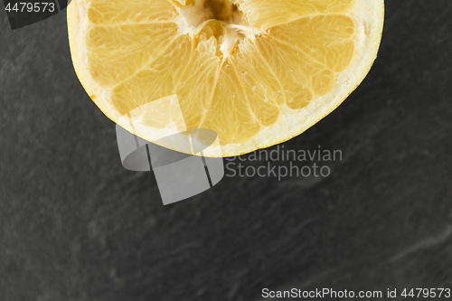 Image of close up of lemon slice on slate table top