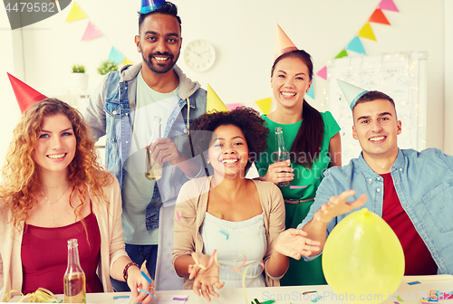 Image of happy team having fun at office party