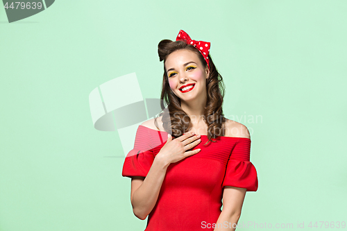 Image of Beautiful young woman with pinup make-up and hairstyle. Studio shot on white background