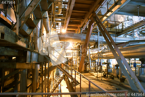 Image of Pipes, tubes, machinery and steam turbine at a power plant