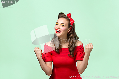 Image of Beautiful young woman with pinup make-up and hairstyle. Studio shot on white background