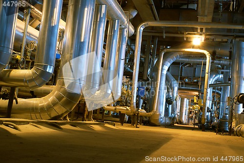 Image of Pipes, tubes, machinery and steam turbine at a power plant