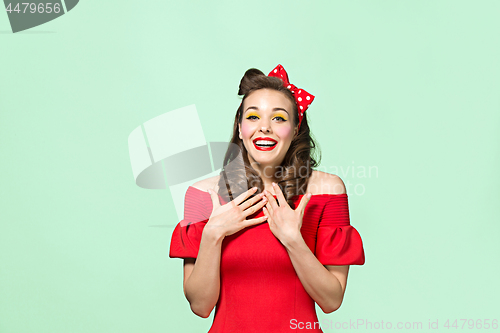 Image of Beautiful young woman with pinup make-up and hairstyle. Studio shot on white background