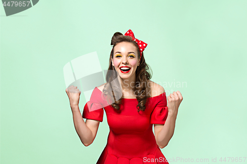 Image of Beautiful young woman with pinup make-up and hairstyle. Studio shot on white background