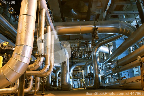 Image of Pipes, tubes, machinery and steam turbine at a power plant