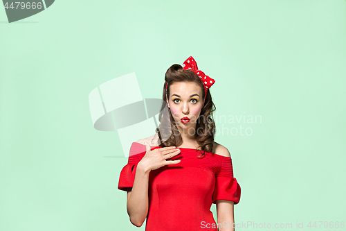 Image of Beautiful young woman with pinup make-up and hairstyle. Studio shot on white background