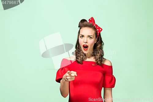 Image of Beautiful young woman with pinup make-up and hairstyle. Studio shot on white background