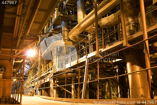 Image of Pipes, tubes, machinery and steam turbine at a power plant