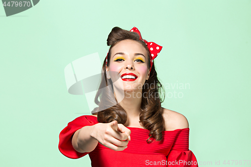 Image of Beautiful young woman with pinup make-up and hairstyle. Studio shot on white background