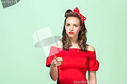 Image of Beautiful young woman with pinup make-up and hairstyle. Studio shot on white background