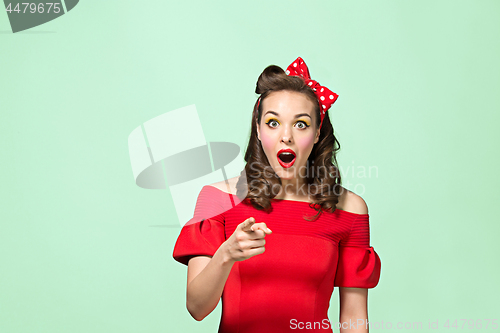 Image of Beautiful young woman with pinup make-up and hairstyle. Studio shot on white background