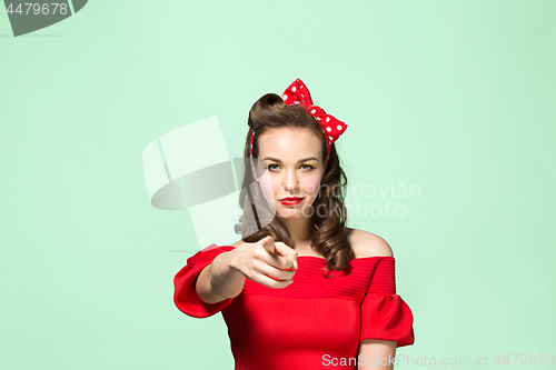 Image of Beautiful young woman with pinup make-up and hairstyle. Studio shot on white background