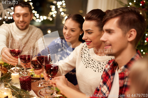 Image of friends celebrating christmas and drinking wine