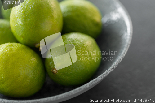 Image of close up of whole limes in bowl