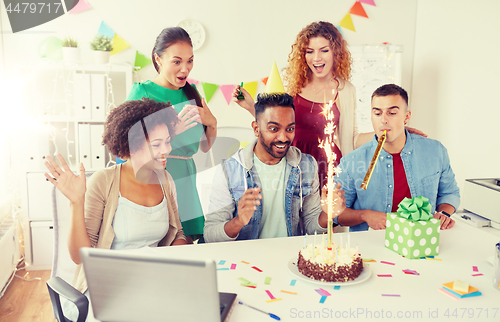 Image of office team greeting colleague at birthday party