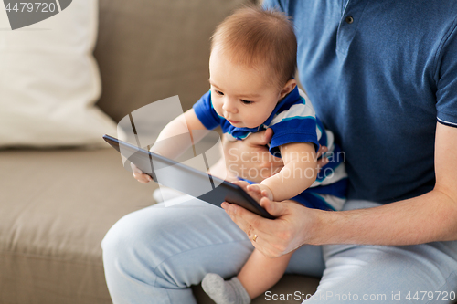 Image of baby and father with tablet pc at home