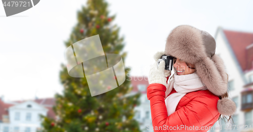 Image of woman with camera over christmas tree in tallinn