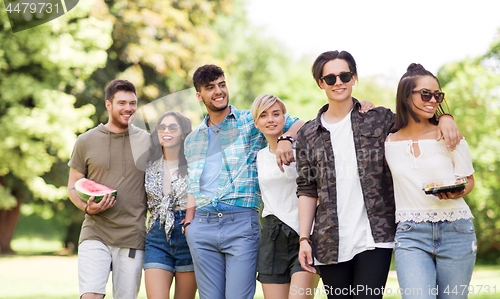 Image of friends with watermelon and snack at summer park