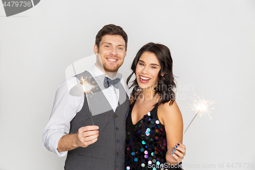 Image of happy couple with sparklers at party