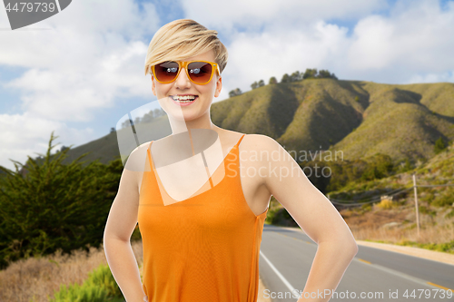 Image of happy smiling teenage girl over big sur hills 