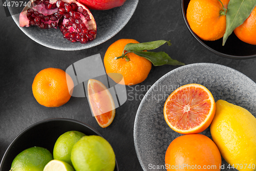 Image of close up of citrus in bowls fruits on stone table