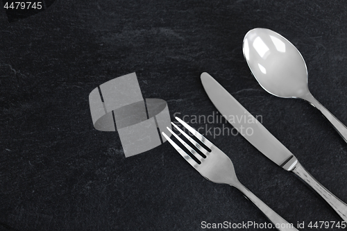 Image of close up of fork, knife and spoon on table