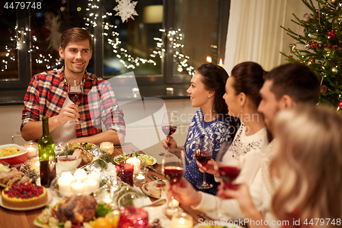 Image of friends celebrating christmas and speaking toast