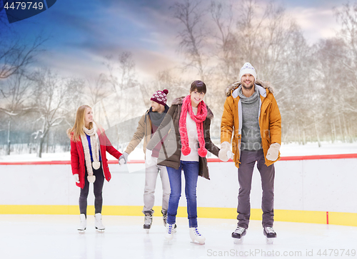 Image of happy friends on outdoor skating rink