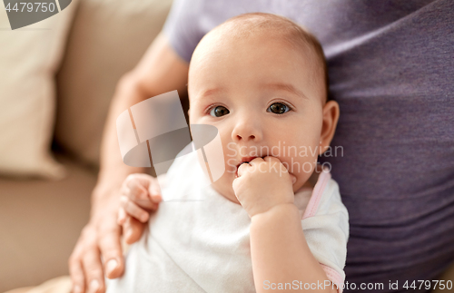 Image of close up of father with little baby girl at home