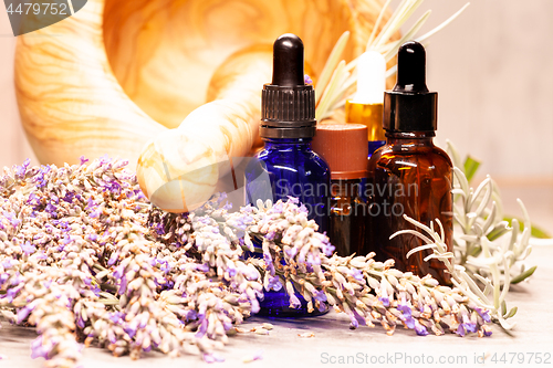 Image of lavender mortar and pestle and bottles of essential oils for aro