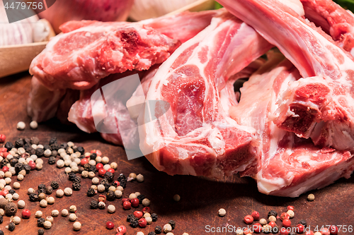 Image of raw lamb chops on a wooden board for barbecue