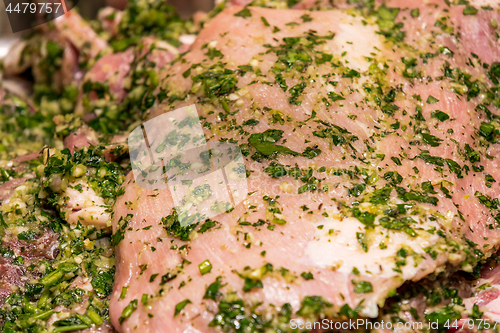 Image of raw meats marinated in garlic olive oil parsley salt pepper