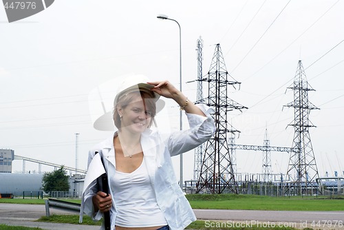 Image of Woman engineer or architect with white safety hat drawings and e