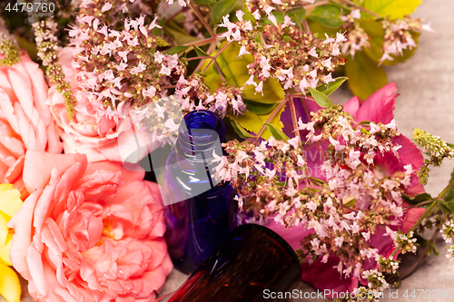 Image of flowers and bottles of essential oils for aromatherapy