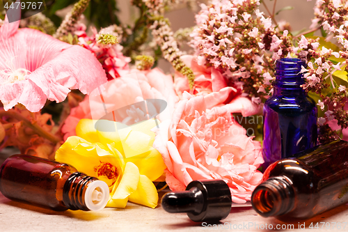 Image of flowers and bottles of essential oils for aromatherapy