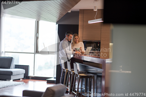 Image of A young couple is preparing for a job and using a laptop